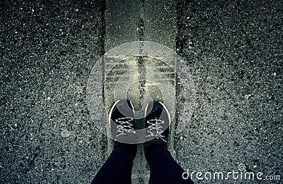 Woman's feet on the asphalt Stock Photo