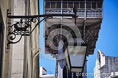 Detail lf a traditional lamp post with the Santa Justa Lift Elevador de Santa Justa on the background in Lisbon Stock Photo