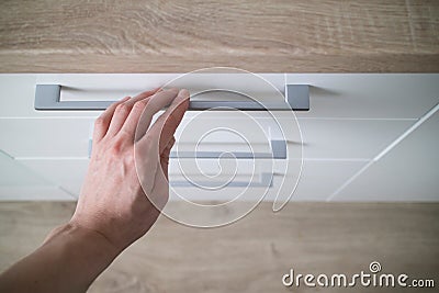 Detail man hand is open of a laminate stylish kitchen drawer Stock Photo