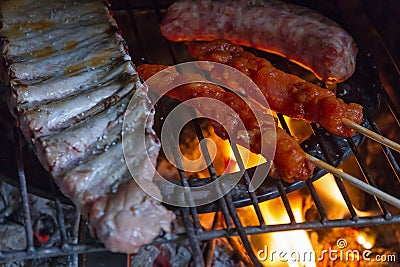 Detail of meat on barbecue fire Stock Photo