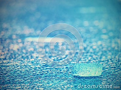 Detail of melting ice block floating in the river. Frozen river surface Stock Photo