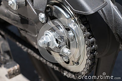 Detail of a motorcycle wheel, swingarm, sprocket and rear drive chain Stock Photo