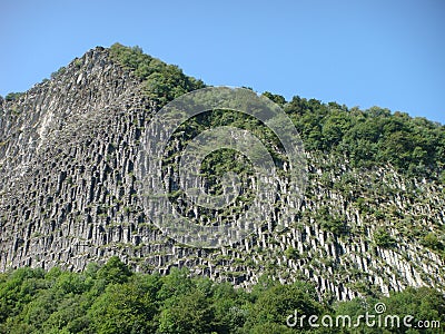 Detail of a mountain of basalt with columnar jointing in the Auvergne Volcanos in France. Stock Photo