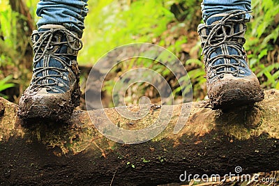 Detail of muddy boots in the way to the Lost three waterfalls hike in the highlands close to boquete, Panama Stock Photo