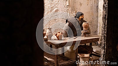 detail of Nativity scene: craftsman works ceramic amphorae Editorial Stock Photo