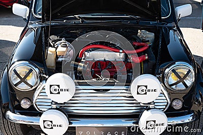 Detail of an old black Mini Cooper with an open hood Editorial Stock Photo