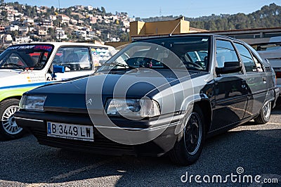 Detail of an old dark grey Citroen BX with hydropneumatic suspension. Editorial Stock Photo