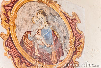 A detail of an old fresco painted on the external wall of the little chapel of St. Johan in Val di Funes Stock Photo