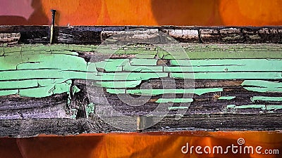 Detail of an old wooden window frame with peeling green paint, shades and nails on a sunny day Stock Photo