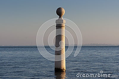 Detail of one of the columns at the Cais das Colunas and the Tagus River in the city of Lisbon Stock Photo