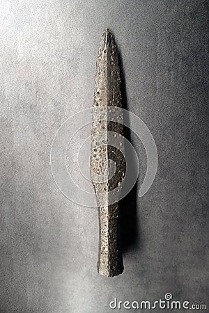 Detail of original prehistoric or medieval weapons - spear, used by tribes for hunting. Rustic iron weapon found by archeologists Stock Photo