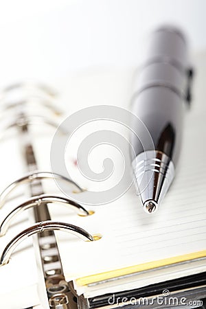 Detail of pen and opened agenda Stock Photo