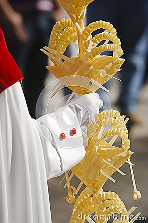 Detail penitent holding a palm during Holy Week on Palm sunday Stock Photo
