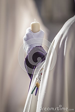 Detail penitent white holding a candle during Holy Week Stock Photo
