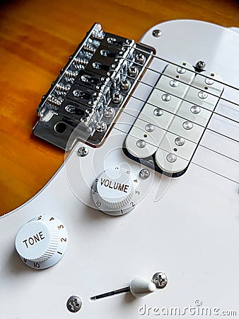 Detail of the pickups of an electric guitar and the volume and tone knobs, selective focus Stock Photo
