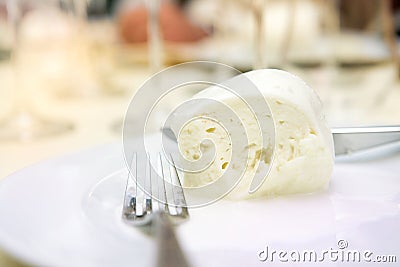 Detail of a piece of italian buffalo mozzarella cheese from Campania region Italy on a laid table Stock Photo