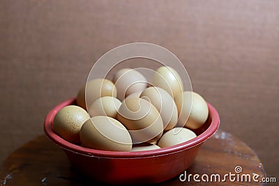 Detail of pile of eggs in red basin Stock Photo