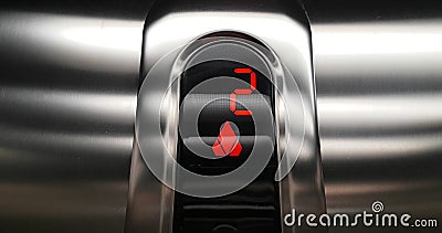Detail of red led with number two of elevator that go up from second to third floor, business and technology Stock Photo