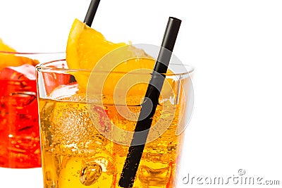 Detail of red and yellow cocktail with orange slice on top and straw isolated on white background Stock Photo