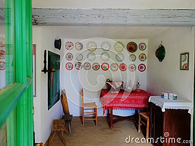 Detail from a retro nineteen century farm house, table, chairs red tablecloth Stock Photo