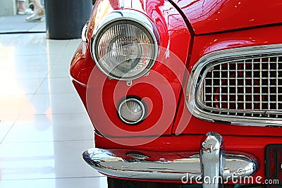 Detail of right headlight and bumper of veteran Czechoslovak car Skoda Felicia from year 1961, red colour. Editorial Stock Photo