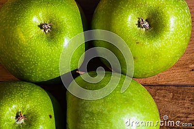 Detail on ripe green apples on wooden table Stock Photo