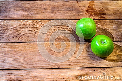 Detail on ripe green apples on wooden table Stock Photo