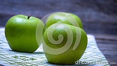 Detail on ripe green apples on wooden table Stock Photo