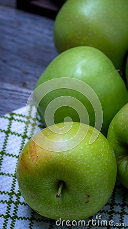 Detail on ripe green apples on wooden table Stock Photo