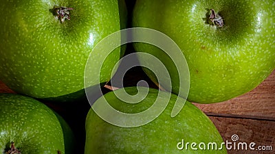 Detail on ripe green apples on wooden table Stock Photo