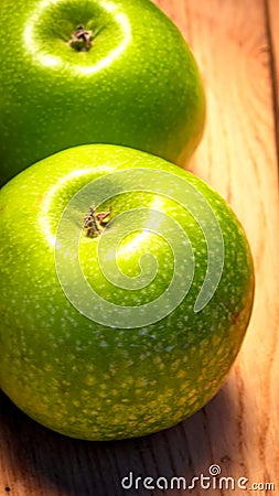 Detail on ripe green apples on wooden table Stock Photo