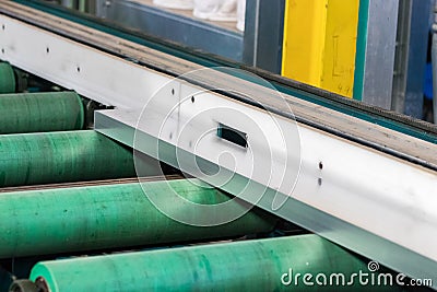 Rollers of an aluminium extrusion profile roller runout table Stock Photo