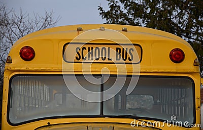 Detail of school bus from america yellow color front view of window lights and bus sign in letters Stock Photo