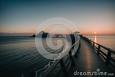 Detail of a seaside boardwalk at sunset Stock Photo