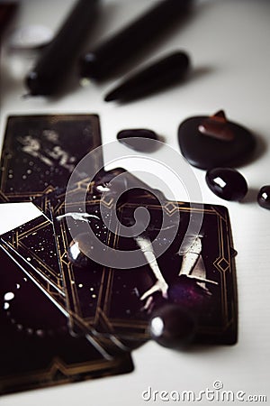 Detail of several black tarot cards with black candles and black stones Stock Photo