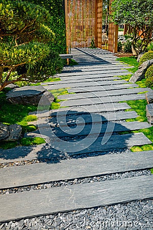 Detail of slate path with bark mulch and native plants in Japanese garden. Landscaping and gardening concept Stock Photo