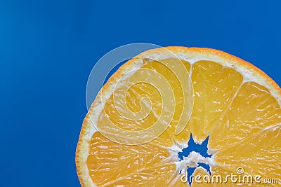 Detail on a Slice Orange on a Blue Background Stock Photo