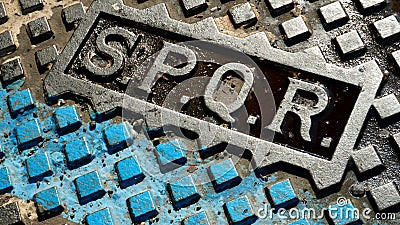 Detail of SPQR writing on the geometric cast iron manhole cover Editorial Stock Photo