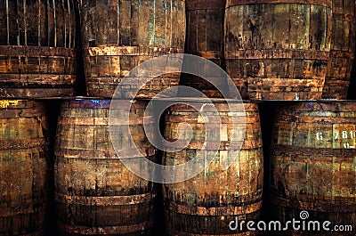 Detail of stacked old wooden whisky barrels Stock Photo