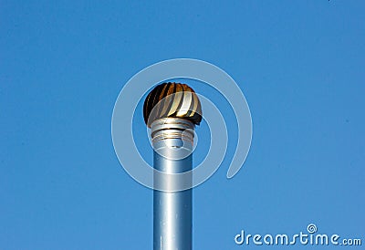 detail of steel chimney with rotating head on a background of blue sky Stock Photo