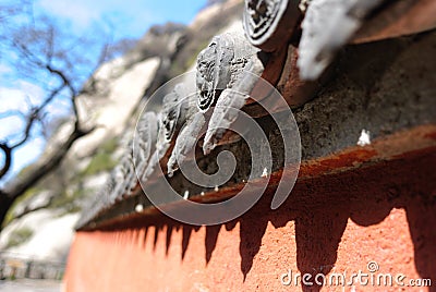 The detail of stone carving on the roof of asian monastery Stock Photo