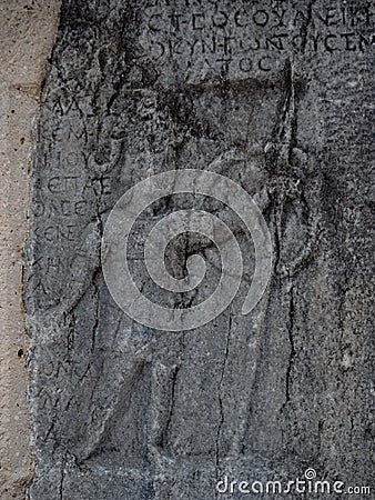 Detail of Stone Carving of Warrior and Surrounding Script at Ruins of Philippi Greece Stock Photo