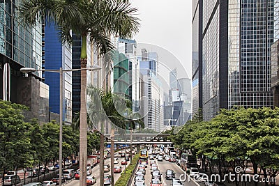 Detail of a street in central Hong Kong with many people walking on the street. On background local shops and restaurants Editorial Stock Photo