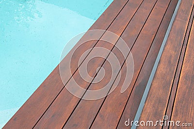 Detail of swimming pool coping and cover constructed by cumaru wood deck, hardwood decking texture next water Stock Photo