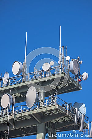 Detail of a telecommunication tower with directional mobile phone and internet antennas. Wireless communication equipment Stock Photo