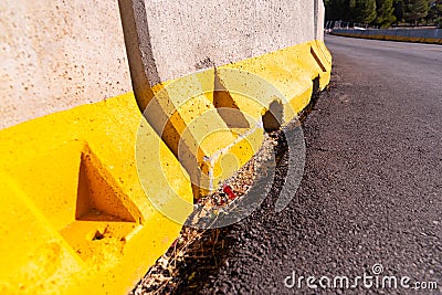 Detail of temporary concrete barricade walls on a newly paved road Stock Photo