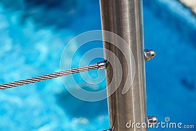 Detail of thermal swimming pool tiled stairs down water and metal handle Stock Photo