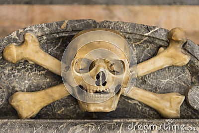 Detail from the tomb decoration. Marble skull with bones Stock Photo