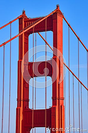 Detail of top of Golden Gate Bridge with vibrant sunset reds Stock Photo