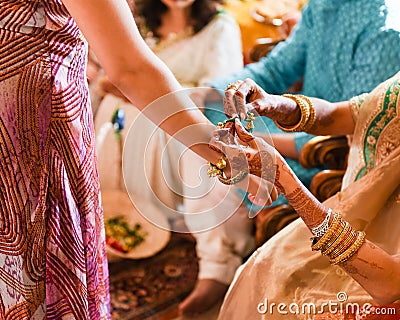 Detail of a traditional Indian religious wedding - bride wearing beautiful garments, jewelry and henna tattoo Stock Photo